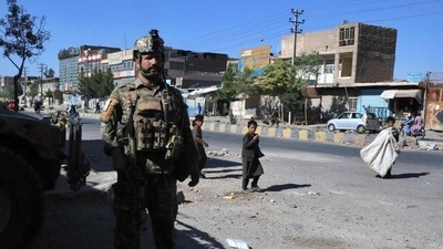 An Afghan security personnel stands guard along the roadside in Herat on Thursday as the Taliban took over the police headquarters in Herat, Afghanistan's third-largest city and also seized another key district capital just 150 kilometres from capital Kabul.&nbsp; (AFP Photo)