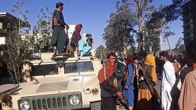 Taliban fighters stand guard along the roadside in Herat, Afghanistan's third biggest city, after government forces pulled out. (AFP) Taliban fighters stand guard along the roadside in Herat, Afghanistan's third biggest city, after government forces pulled out. (AFP)