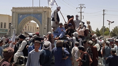 Taliban fighters stand on a vehicle along the roadside in Kandahar on August 13, 2021. (AFP) Taliban fighters stand on a vehicle along the roadside in Kandahar on August 13, 2021. (AFP)