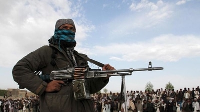 A member of the Taliban insurgent and other people stand during an execution in Ghazni province, Afghanistan.&nbsp; (File Photo / REUTERS)