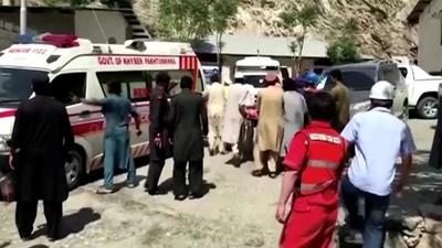 People wheel a gurney towards an ambulance outside a hospital in Dasu, after a bus with Chinese nationals on board plunged into a ravine on July 14, in this still image taken from video. (REUTERS) People wheel a gurney towards an ambulance outside a hospital in Dasu, after a bus with Chinese nationals on board plunged into a ravine on July 14, in this still image taken from video. (REUTERS)