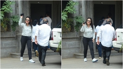 Kareena Kapoor wore a simple grey jacket with a front zipper. She teamed it with black joggers, a black face mask, sunglasses, and lace-up sneakers. (Varinder Chawla)