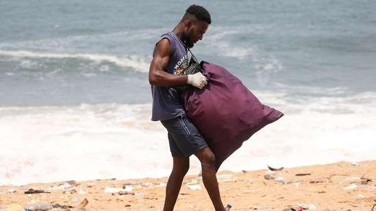Aristide Kouame, 26, transforms the flotsam into artworks valued at up to $1,000 by cutting the rubber and plastic soles into pieces that he assembles into large collages.(REUTERS)