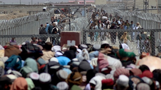 Stranded people crossing the border between Pakistan Afghanistan, in Chaman, Pakistan, Friday, August &nbsp;13.&nbsp;(AP)