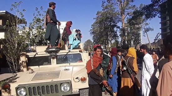 Taliban fighters stand guard along the roadside in Herat, Afghanistan's third biggest city, after government forces pulled out.(AFP)