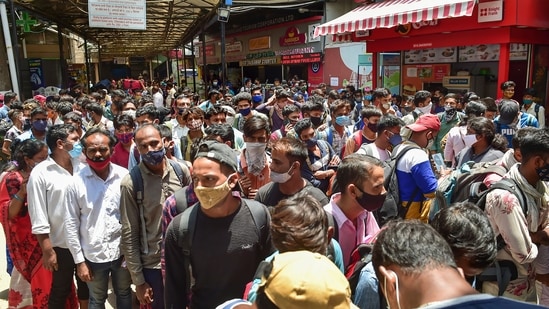 Passengers wait to undergo Covid-19 testing at a railway station in Bengaluru.(PTI)