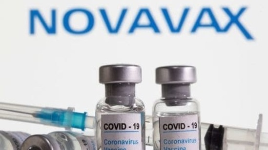 Vials labelled "COVID-19 Coronavirus Vaccine" and sryinge are seen in front of displayed Novavax logo in this illustration (Reuters).
