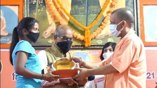 Uttar Pradesh chief minister Yogi Adityanath felicitating a local sportsperson in Gorakhpur on Friday. (SOURCED IMAGE)