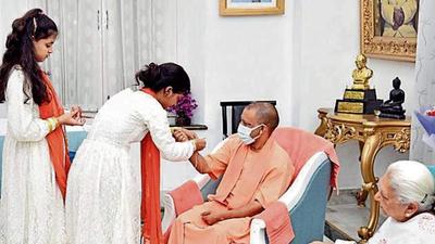 Girls tying rakhi to Uttar Pradesh chief minister Yogi Adityanath on the eve of Independence Day in Lucknow on Saturday. (SOURCED IMAGE)