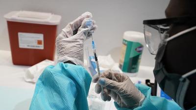 A health care worker fills a syringe with the Pfizer Covid-19 vaccine in New York, US. (AP) A health care worker fills a syringe with the Pfizer Covid-19 vaccine in New York, US. (AP)