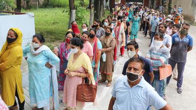 People wait in long queues to receive Covid-19 vaccine dose at a vaccination centre in Jammu. (PTI)