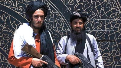 Taliban fighters stand guard in front of the provincial governor's office in Herat on August 14, 2021. (AFP) Taliban fighters stand guard in front of the provincial governor's office in Herat on August 14, 2021. (AFP)