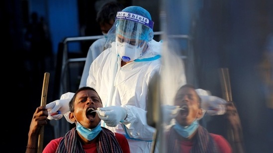 A healthcare worker collects a coronavirus disease (Covid-19) test swab sample from a man.&nbsp;(File Photo / REUTERS)