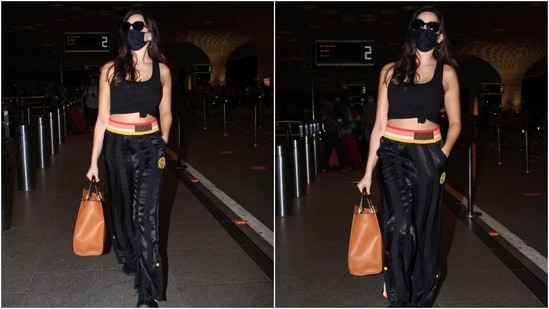 Nora teamed the top with black Fendi joggers featuring a multi-coloured band, shiny black strips and a gathered hem. She completed her look with black lace-up chunky shoes and sunglasses.(Varinder Chawla)