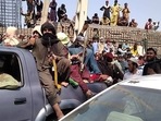 Mazar-i-Sharif and Jalalbad, the two major Afghan cities, were captured by the militants earlier on Sunday. In picture - Taliban fighters sit on a vehicle along the street in Jalalabad province.