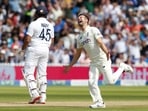 Mark Wood (R) celebrates the wicket of Rohit Sharma (L)