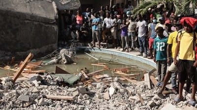 Residents survey a damaged building following a 7.2-magnitude earthquake in Les Cayes, Haiti, on Sunday, Aug. 15, 2021. The U.S. deployed search and rescue teams to help find survivors among the debris of collapsed buildings in Haiti as the death toll soars from Saturday's massive earthquake. (Bloomberg) Residents survey a damaged building following a 7.2-magnitude earthquake in Les Cayes, Haiti, on Sunday, Aug. 15, 2021. The U.S. deployed search and rescue teams to help find survivors among the debris of collapsed buildings in Haiti as the death toll soars from Saturday's massive earthquake. (Bloomberg)