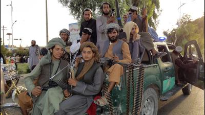 Taliban fighters patrol inside the city of Kandahar province southwest, of Afghanistan, on Sunday. (AP)