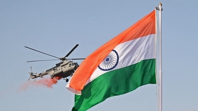 An Indian Air Force (IAF) helicopter flies past the national flag while showering flower petals during the celebrations to mark India's 75th Independence Day at the Red Fort in New Delhi on August 15. (AFP) An Indian Air Force (IAF) helicopter flies past the national flag while showering flower petals during the celebrations to mark India's 75th Independence Day at the Red Fort in New Delhi on August 15. (AFP)