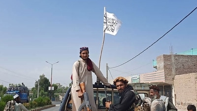 Taliban fighters drive an Afghan National Army (ANA) vehicle through the streets of Laghman province on August 15, 2021.&nbsp; (AFP)