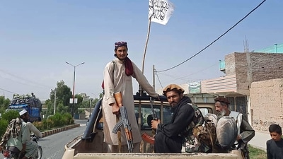 Taliban fighters drive an Afghan National Army (ANA) vehicle through the streets of Laghman province on August 15, 2021. (Representational Image / AFP) Taliban fighters drive an Afghan National Army (ANA) vehicle through the streets of Laghman province on August 15, 2021. (Representational Image / AFP)