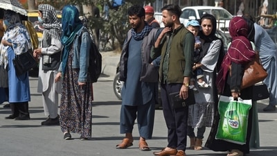 Afghan people stand along the roadside as they wait for taxi in Kabul. (AFP) Afghan people stand along the roadside as they wait for taxi in Kabul. (AFP)