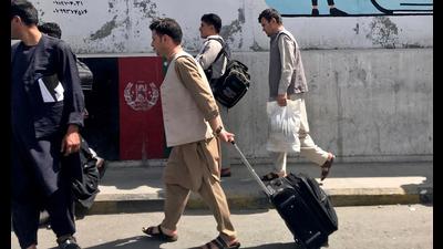 Afghans walk toward the airport in Kabul, Afghanistan on Sunday. Taliban fighters began entering Kabul from all sides without facing any resistance by late Sunday afternoon. The move came hours after the Taliban captured Jalalabad, the last major city in the north that was under government control, without a struggle. (REUTERS PHOTO.) Afghans walk toward the airport in Kabul, Afghanistan on Sunday. Taliban fighters began entering Kabul from all sides without facing any resistance by late Sunday afternoon. The move came hours after the Taliban captured Jalalabad, the last major city in the north that was under government control, without a struggle. (REUTERS PHOTO.)