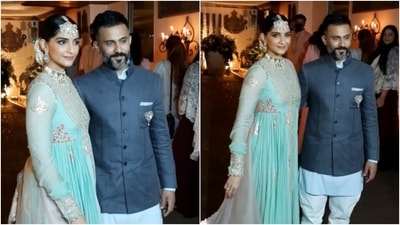One of Bollywood's most adorable couple, Sonam Kapoor and Anand Ahuja posed for the paparazzi as they twinned in blue ensembles. (HT Photo/Varinder Chawla)
