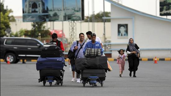 Passengers walk to the departures terminal of Hamid Karzai International Airport in Kabul as Taliban offensive reaches the Afghan capital. (AP Photo/representative use)