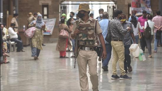 Verification of vaccination certificates and issuing of universal passes was taking place outside railway stations. (PTI) Verification of vaccination certificates and issuing of universal passes was taking place outside railway stations. (PTI)