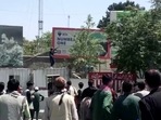 A Taliban fighter holds a weapon while standing on a building outside Kabul airport, Kabul, Afghanistan(REUTERS ) A Taliban fighter holds a weapon while standing on a building outside Kabul airport, Kabul, Afghanistan(REUTERS )