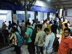 Fully vaccinated commuters queue up for local train passes in Thane on Monday after the Maharashtra government relaxed Covid-19 lockdown restrictions.