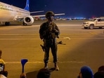 A US army soldier stands guard as Afghans wait to leave from the airport in Kabul(AFP) A US army soldier stands guard as Afghans wait to leave from the airport in Kabul(AFP)