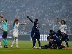 Bordeaux's Samuel Kalu lays on the pitch as players call the medic during the French League One soccer match between Marseille and Bordeaux at the Velodrome stadium in Marseille, southern France, Sunday, Aug. 15, 2021. (AP Photo/Daniel Cole)(AP)