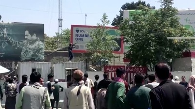 A Taliban fighter holds a weapon while standing on a building outside Kabul airport, Kabul, Afghanistan (REUTERS ) A Taliban fighter holds a weapon while standing on a building outside Kabul airport, Kabul, Afghanistan (REUTERS )