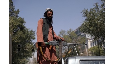 A Taliban fighter stands guard at the main gate leading to the Afghan presidential palace, in Kabul, Afghanistan, Monday, Aug. 16. Afghanistan plunged into crisis as the US troops started withdrawing from the country in May and the Taliban made rapid advances capturing city after city.&nbsp;The U.S. military struggled to manage a chaotic evacuation from Afghanistan today.&nbsp; (Rahmat Gul / AP)