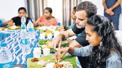 Rahul Gandhi having Sadya (rice on a plantain leaf with many traditional curries) with tribal students from the district, who cracked the common law admission test. (HT Photo)