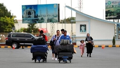 Passengers walk to the departures terminal of Hamid Karzai International Airport in Kabul, Afghanistan. (AP) Passengers walk to the departures terminal of Hamid Karzai International Airport in Kabul, Afghanistan. (AP)