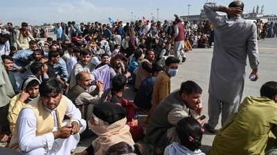 Afghan passengers sit as they wait to leave the Kabul airport. (AFP) Afghan passengers sit as they wait to leave the Kabul airport. (AFP)