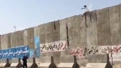 Video shows a Taliban fighter shooting at an unarmed individual trying to enter the Kabul airport by scaling the wall. (Saad Mohseni/Twitter)