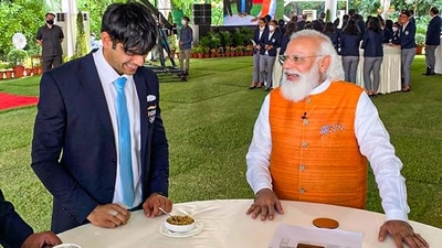 Prime Minister Narendra Modi treated Tokyo Olympics gold medalist, athlete Neeraj Chopra to 'churma' during a felicitation ceremony at PM's residence in New Delhi on August 16. (PTI) Prime Minister Narendra Modi treated Tokyo Olympics gold medalist, athlete Neeraj Chopra to 'churma' during a felicitation ceremony at PM's residence in New Delhi on August 16. (PTI)
