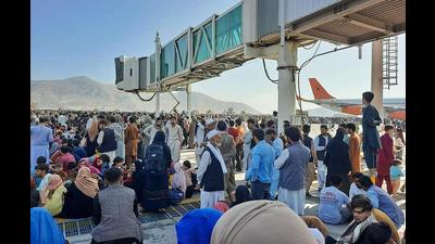 Afghans crowding the tarmac of the Kabul airport on Monday to flee the country as the Taliban were in control of Afghanistan after President Ashraf Ghani fled, conceding the insurgents had won the 20-year war. (AFP Photo)