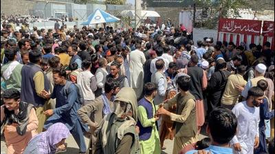 People try to get into Hamid Karzai International Airport in Kabul, Afghanistan, on Monday. (REUTERS) People try to get into Hamid Karzai International Airport in Kabul, Afghanistan, on Monday. (REUTERS)