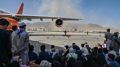 Afghan people waiting to leave Kabul on Monday, after a stunningly swift end to Afghanistan's 20-year war, as thousands of people mobbed the city's airport trying to flee the group's feared hardline brand of Islamist rule. (AFP PHOTO.)
