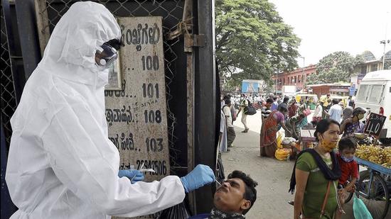 A health worker collects swab sample from a man for a Covid-19 test in Bengaluru. (PTI)