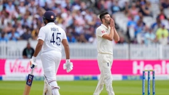 England's bowler Mark Wood, right, reacts after India's Rohit Sharma hit him for six runs.(AP)