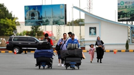 Passengers walk to the departures terminal of Hamid Karzai International Airport in Kabul, Afghanistan.(AP)