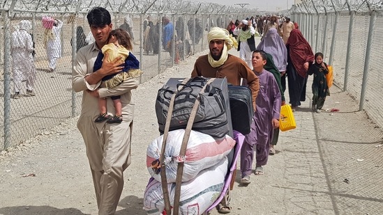 Stranded Afghan nationals arrive to return back to Afghanistan at the Pakistan-Afghanistan border crossing point in Chaman.(AFP)