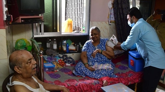 A healthcare worker administers a dose of Covid-19 vaccine to a beneficiary during door-to-door vaccination drive in Mumbai.(Bhushan Koyande/HT File Photo)