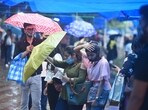 Visitors caught in the rain at Janpath market, in New Delhi last week. (Raj K Raj / Hindustan Times))